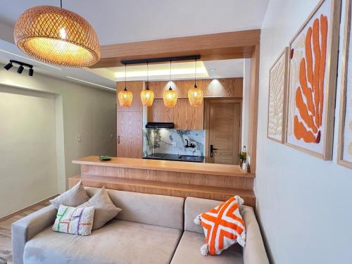 a living room with a couch and a tv at Urban Nest Agadir - City Center Apartment in Agadir