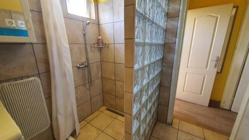 a bathroom with a shower with a glass door at Holiday home in Szantod - Balaton 31357 in Szántód