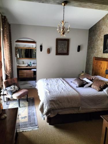 une chambre avec un grand lit et une chaise dans l'établissement charmante villa 6 pers au calme, à Sainte-Maxime