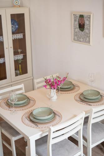 a dining room table with plates and flowers on it at Galinos-traditional house B in Eresos