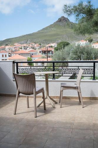 two chairs and a table on a balcony at Galinos-traditional house B in Eresos