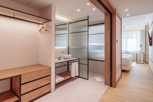 a bathroom with a shower and a sink at Hotel Murcia Rincón de Pepe Affiliated by Meliá in Murcia
