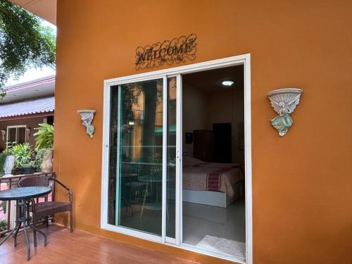 a building with a door leading to a patio at Kireeya Villa in Phetchaburi