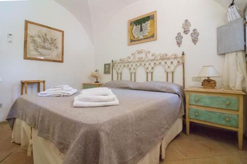 a bedroom with a bed with towels on it at GuestHost - Porto Cervo Liscia di Vacca Apartment in Liscia di Vacca
