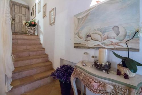 a stairway with a painting of swans on the wall at GuestHost - Porto Cervo Liscia di Vacca Apartment in Liscia di Vacca