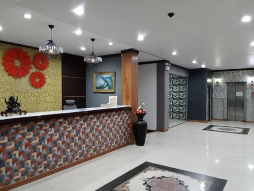 a lobby of a hotel with a reception counter at PS Hotel Saraburi in Sara Buri
