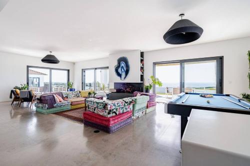 a living room with couches and a pool table at Bica Vista in Lourinhã