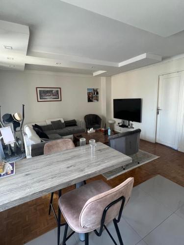 a living room with a table and a couch at appartement 65m in Châtillon