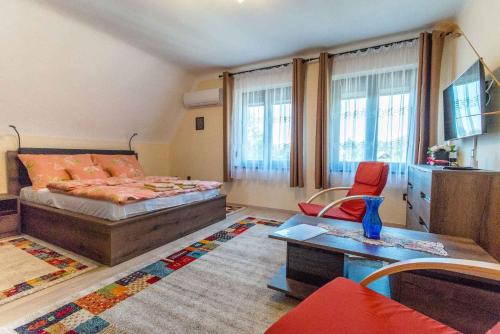 a bedroom with a bed and a table and chairs at Apartment in Balatonkeresztur 48113 in Balatonkeresztúr