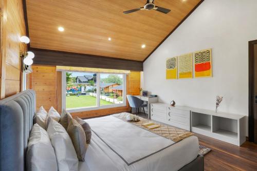 a living room with a bed and a desk at Luxury 4BHK with Garden Pool and Entertainment Space in Palāhu