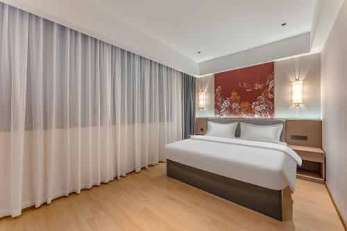Ένα ή περισσότερα κρεβάτια σε δωμάτιο στο Joyston Hotel