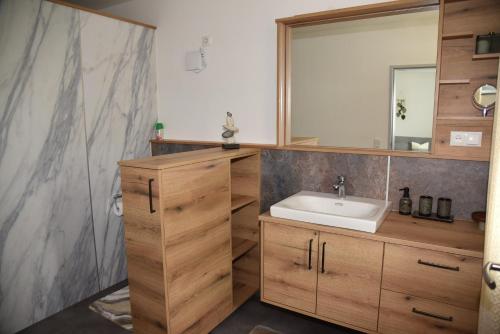 a bathroom with a sink and a mirror at Ferienwohnung Eder in Bad Birnbach