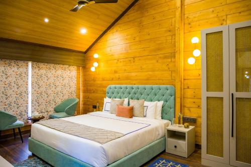 a bedroom with a bed and a wooden wall at Luxury 4BHK with Garden Pool and Entertainment Space in Palāhu
