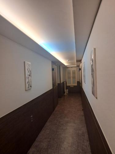 a hallway with a light on the ceiling at Hotel Ravi in Seoul