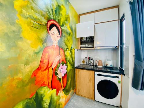 a painting of a woman in a kitchen at Lilo's Homestay West Lake Thuy Khue in Hanoi