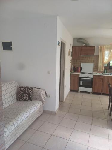 a living room with a couch and a kitchen at Apartment near Olympus mountain in Litochoro