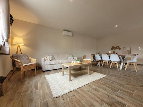 a living room with a couch and a table at gite clos saint martin proche de la baie de somme in Millencourt-en-Ponthieu