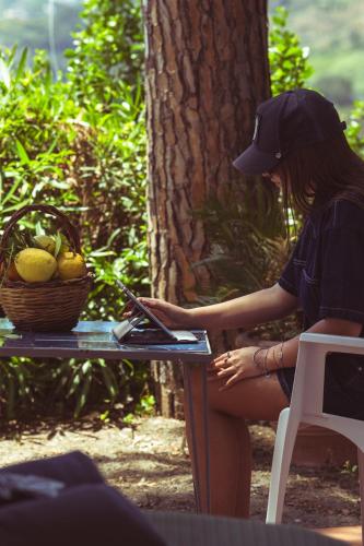 a woman sitting at a table with a basket of lemons at Hotel Sunset Green in Ischia