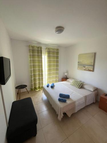 Ένα ή περισσότερα κρεβάτια σε δωμάτιο στο Apartamento Arousa