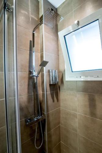 a shower in a bathroom with a window at Preveza Central Stay in Preveza