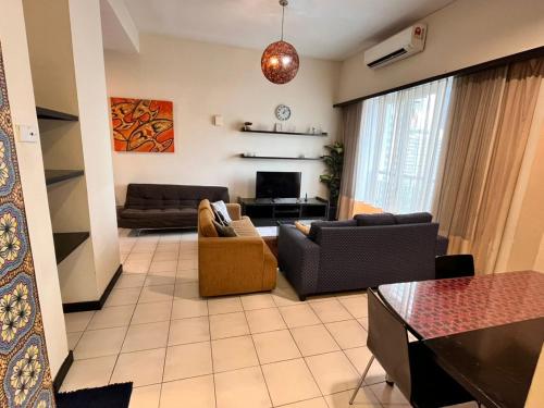 a living room with two couches and a tv at Seri Bukit Ceylon Bukit Bintang in Kuala Lumpur