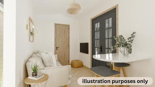 a living room with a white couch and a table at Cotswold Country Retreats in South Cerney