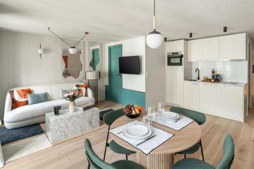 un salon avec une table, des chaises et un canapé dans l'établissement SERENERS Apartments in Montorgueil - Rue Saint-Denis, à Paris