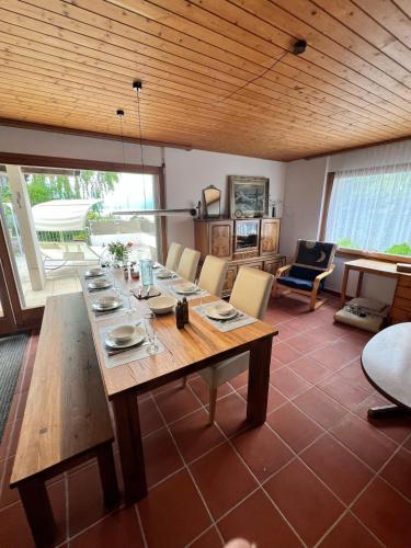a dining room with a wooden table and chairs at Large vacation home with mountain views in Quarten
