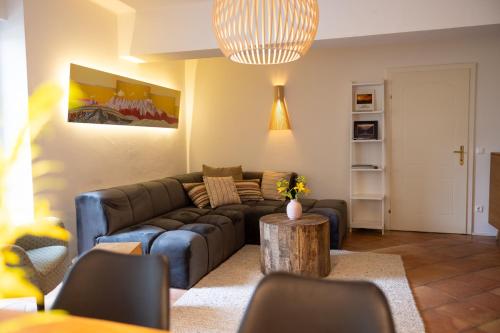 a living room with a couch and a table at Hotel Annelies in Ramsau am Dachstein