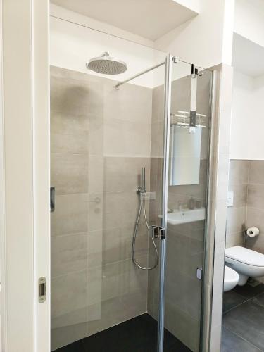 a bathroom with a shower with a sink and a toilet at Bastia Home Plus in Bastia Umbra