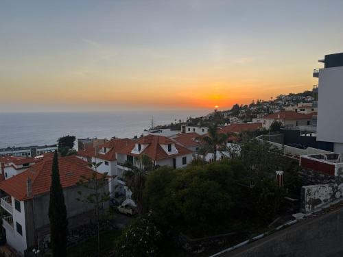 a view of a city at sunset at Atlantic Dream Alto Mar in Garajau