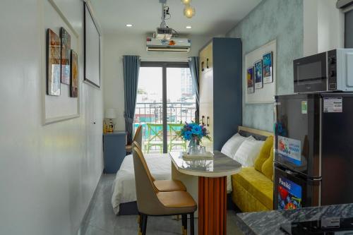 a small room with a table and a yellow couch at Lilo's Homestay West Lake Thuy Khue in Hanoi