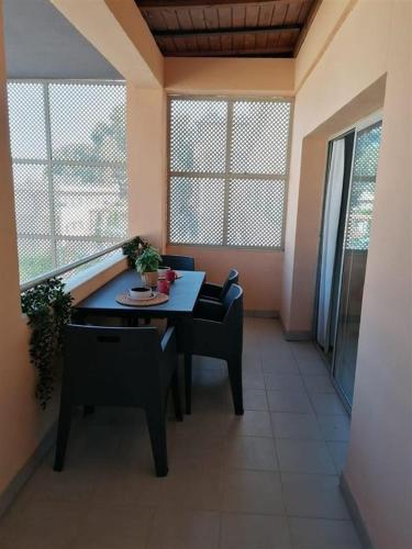 a table and chairs in a room with a balcony at Resa Emperador Carlos V in Granada