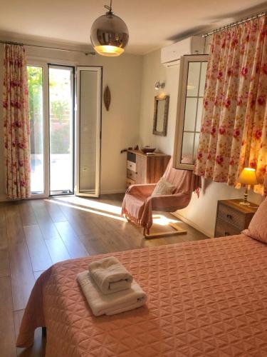a bedroom with a bed with two towels on it at Avli Cottage in Sami