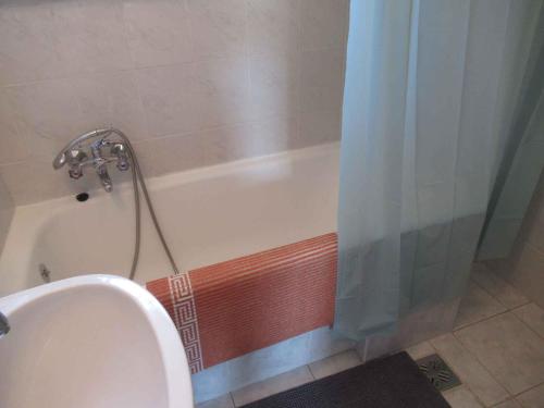 a bathroom with a bath tub with a shower curtain at Holiday home in Balatonfüred 18777 in Balatonfüred