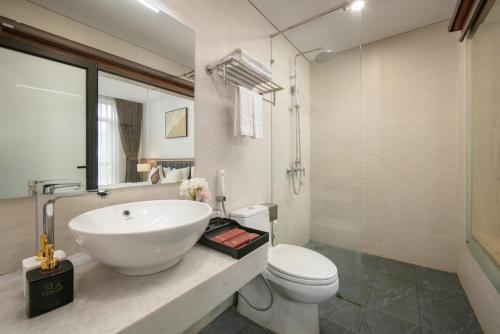 a bathroom with a white sink and a toilet at Lam Anh Hotel 5 Him Lam Vạn Phúc in Hà Ðông