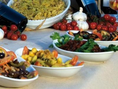 a table topped with bowls of different types of food at Corte dei Monaci in Canicattì