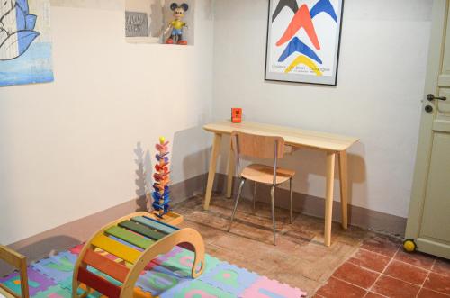 a childs room with a table and a chair at Panoramic Monferrato Villa With Garden & Amazing Views in Murisengo