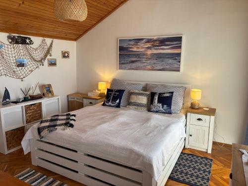 a bedroom with a large bed with pillows on it at Apartmán Stašica in Selce