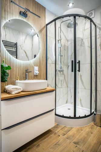 a bathroom with a shower and a sink at Krasowa Ostoya in Kusięta