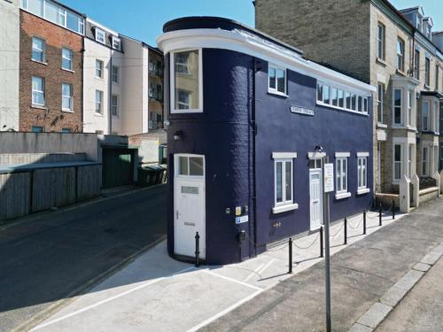 a blue train car on display on a street at Lighthouse Cottage Unique Apartments in Scarborough