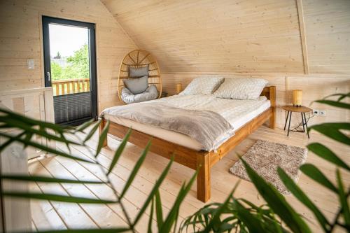 a bedroom with a bed in a wooden room at Krasowa Ostoya in Kusięta