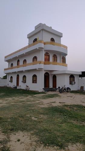 a large white building with a lot of windows at KAPOOR SAHAB HOMESTAY COUNTRYSIDE Its a home away from home in Saraia