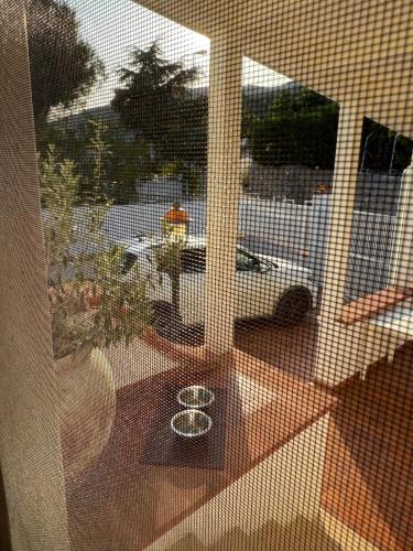 a glass window with a view of a car on a street at Il Villotto in Monte SantʼAngelo
