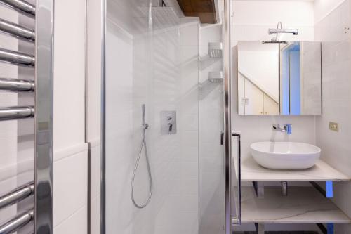 a white bathroom with a sink and a shower at Villa Gia in Someraro