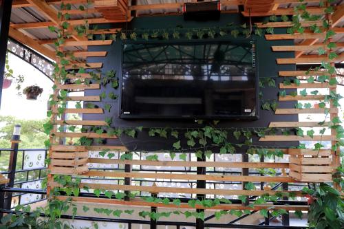 a pergola with a window and plants on it at AG Home - Kampala in Kampala
