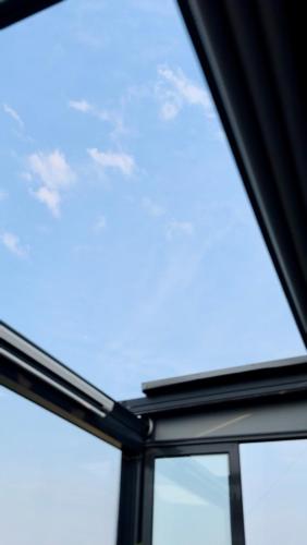 a close up of a glass window with the sky in the background at Spemaré Residence Halkidiki in Nea Kalikratia