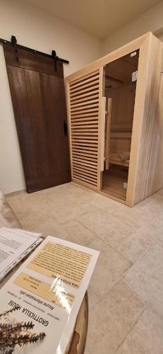 a room with a door and a table with a window at Lajatico Rentals -Grotticella House, SPA Apartment in Peccioli in Peccioli