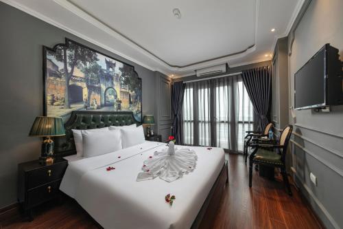 a bedroom with a large bed with a flower on it at Hanoi View Hotel & Travel in Hanoi