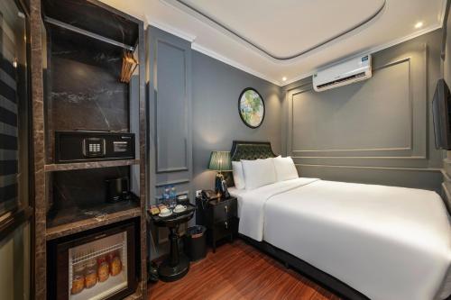 a bedroom with a white bed and a tv at Hanoi View Hotel & Travel in Hanoi